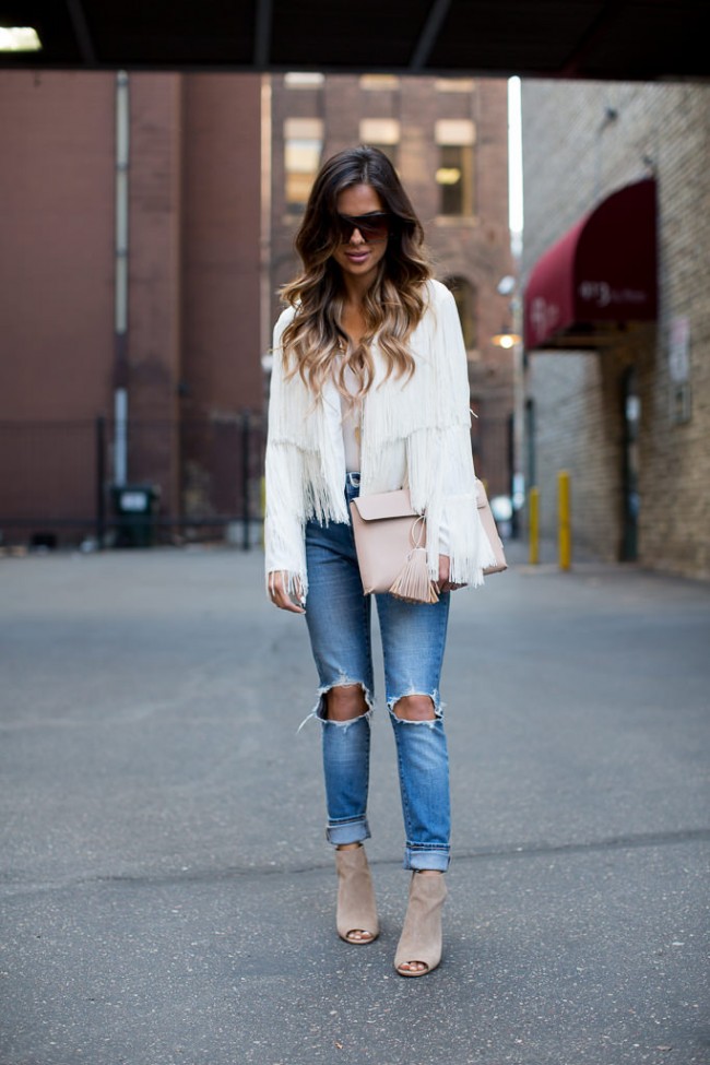 Mia Mia Mine wearing a fringe jacket with ripped jeans