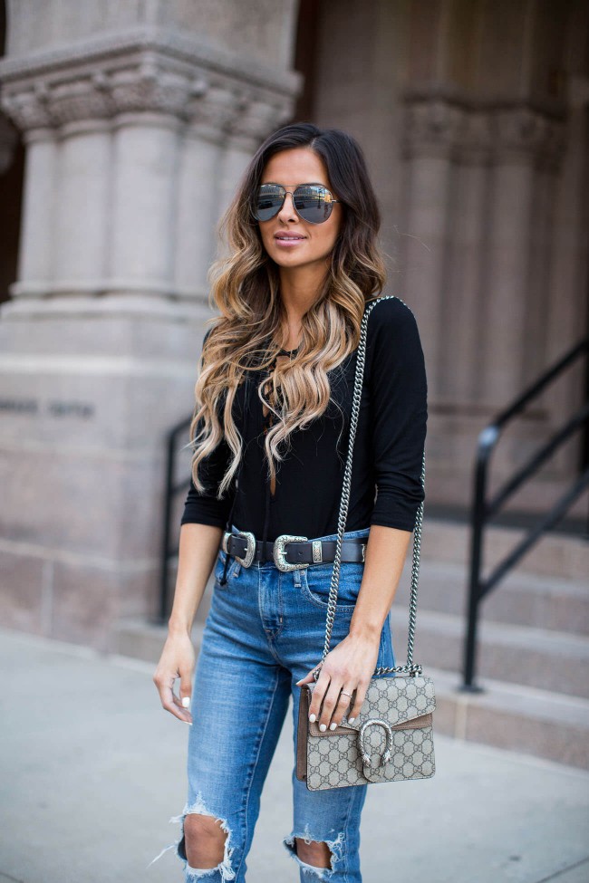 Fashion blogger wearing a black bodysuit and levi's jeans
