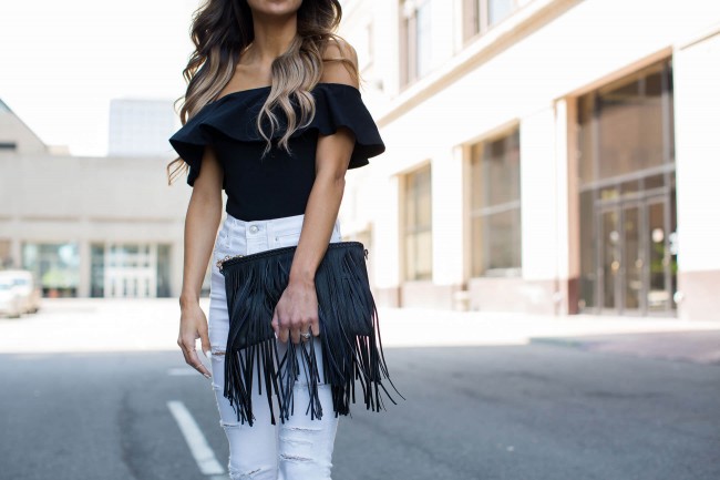 Mia Mia Mine carrying a sole society fringe clutch 