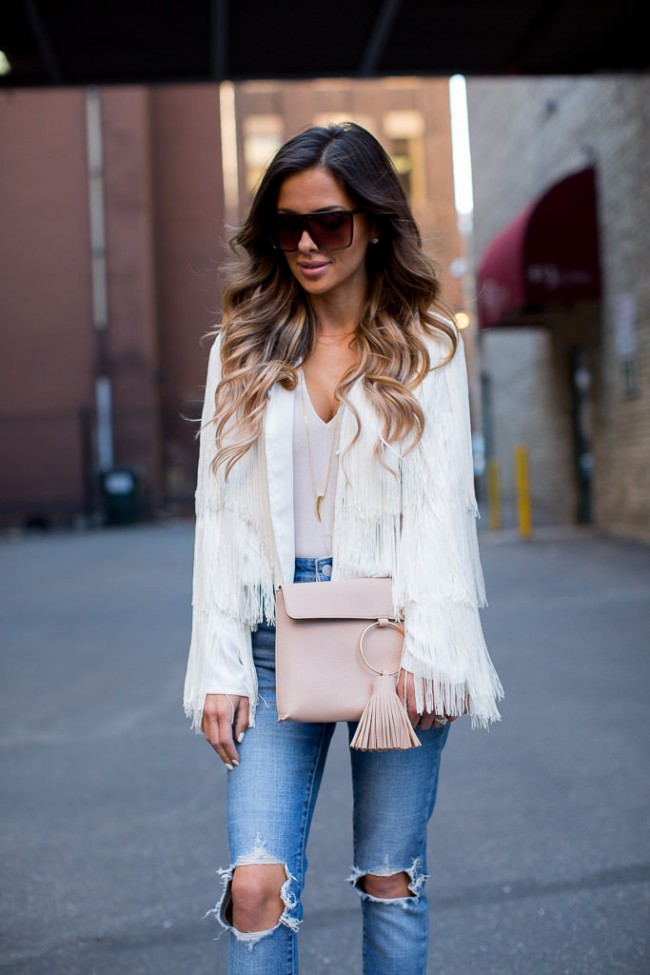 fashion blogger mia mia mine wearing a white fringe jacket from nasty gal