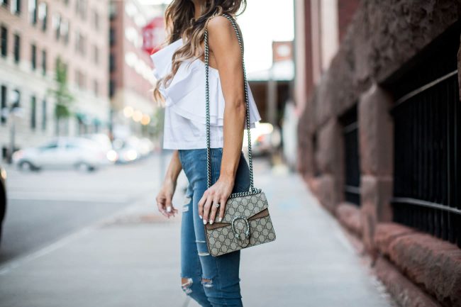 fashion blogger mia mia mine wearing a one shoulder top from topshop and ripped jeans