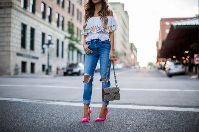fashion blogger mia mia mine in an off-the-shoulder embroidered top from shopbop and pink heels