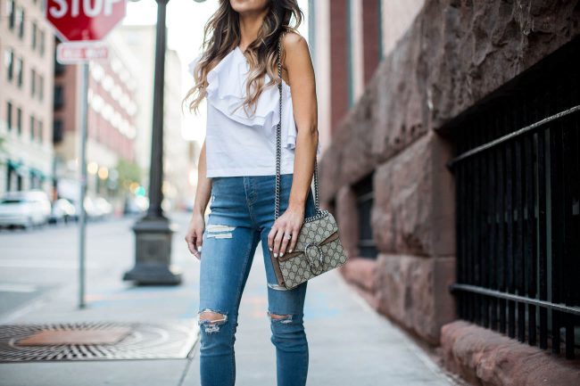 fashion blogger mia mia mine carrying a gucci dionysus bag and wearing topshop jeans