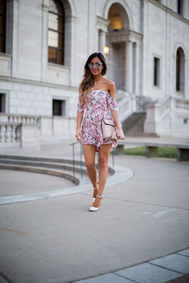 mia mia mine in a rose print romper from shopbop and a pink tassel bag