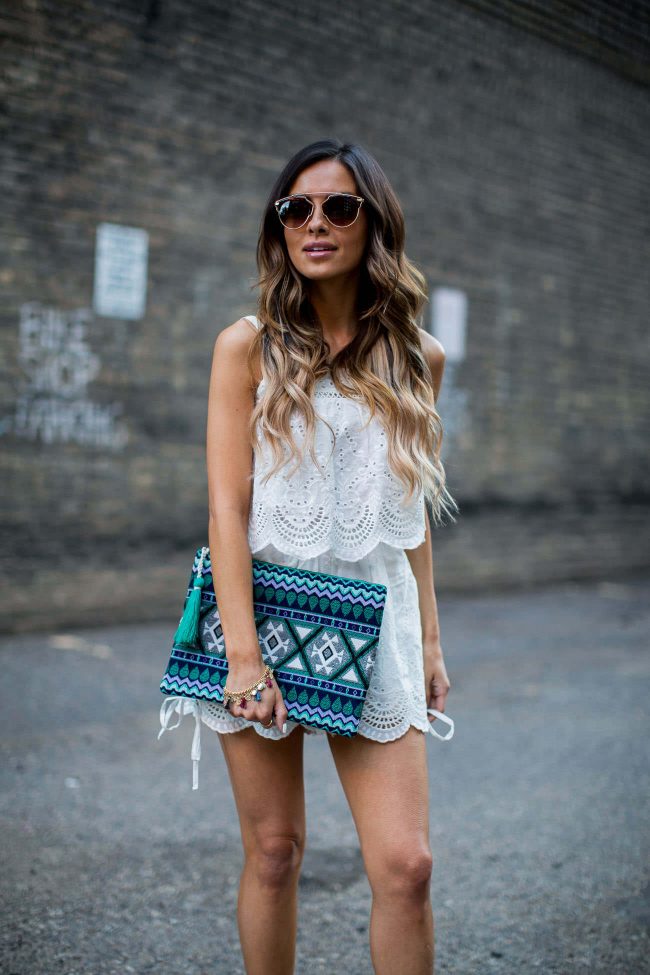 mia mia mine carrying an ethnic print clutch from sole society and wearing a white lace romper