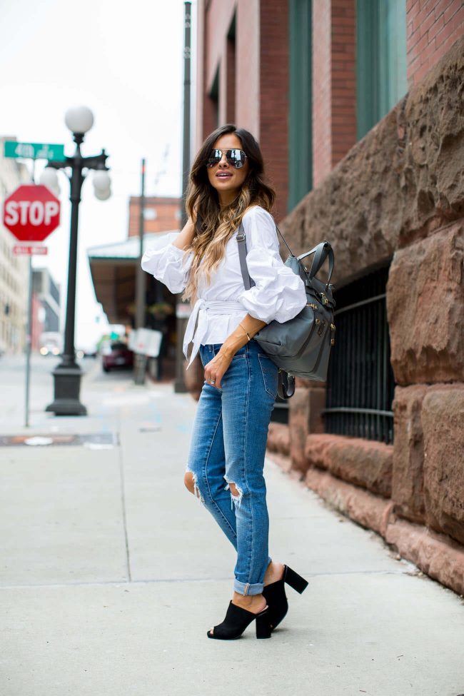 fashion blogger mia mia mine carrying a henri bendel bag and wearing topshop mules