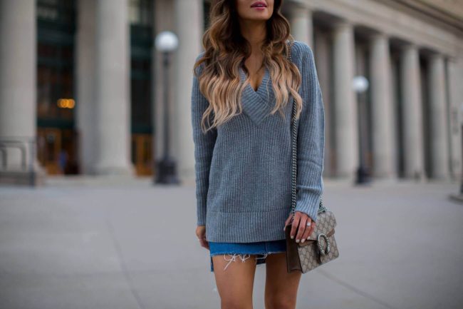 fashion blogger mia mia mine wearing an oversized v-neck sweater and topshop mini skirt