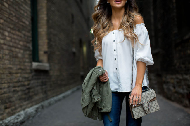 fashion blogger mia mia mine wearing an off-the-shoulder and jeans from new york & company
