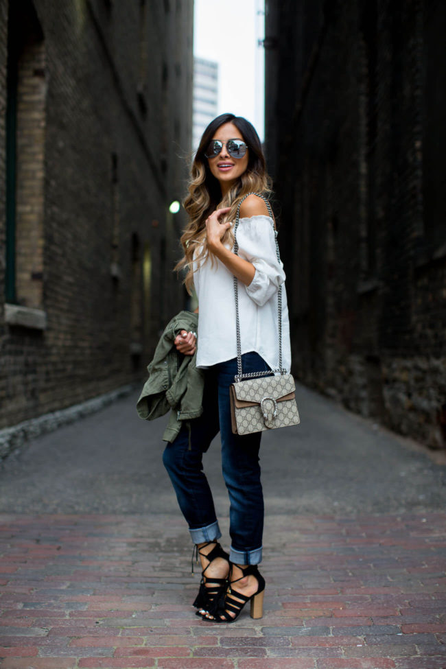 fashion blogger mia mia mine wearing an off-the-shoulder white top from new york & company
