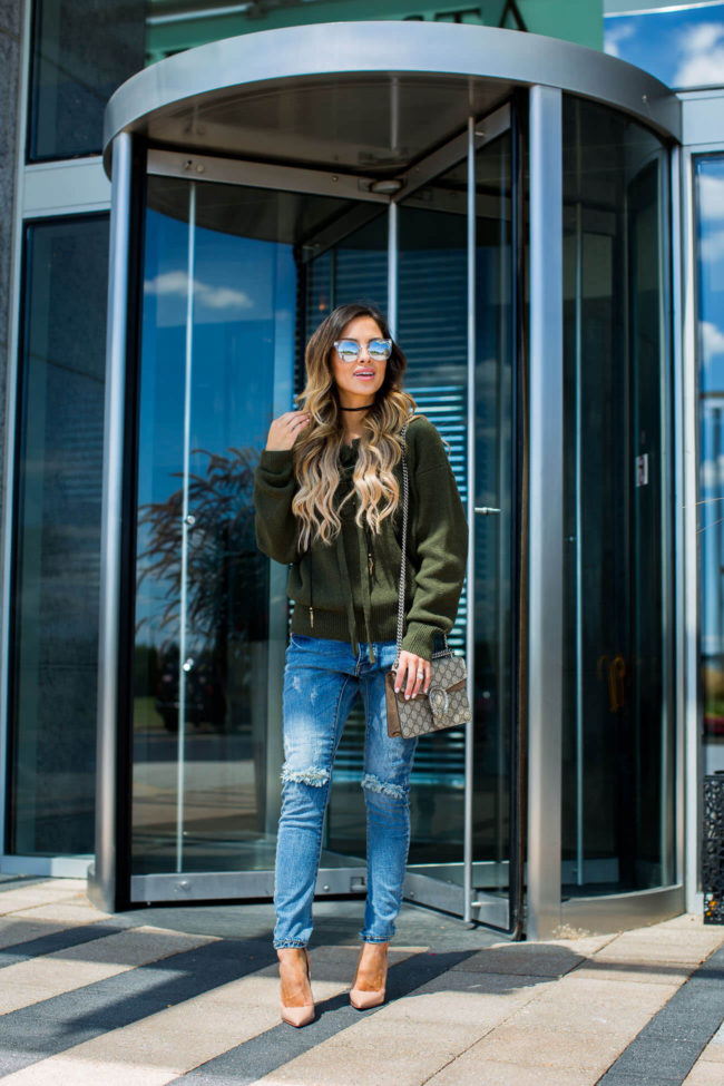 fashion blogger mia mia mine in a lace up sweater and one teaspoon jeans from shopbop