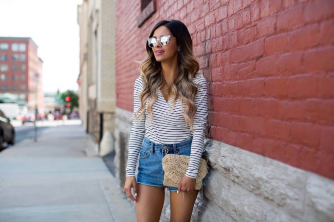 minnesota fashion blogger wearing a striped bodysuit and straw bag from shopbop