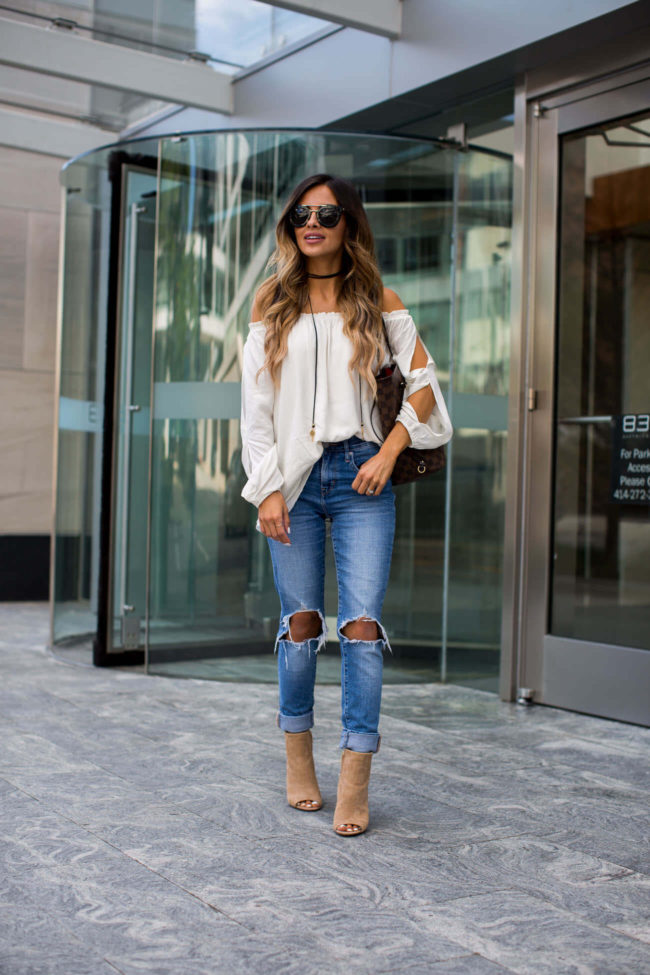fashion blogger mia mia mine wearing a white slit sleeve top by sanctuary and levis jeans