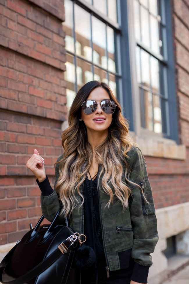 fashion blogger mia mia mine in a camouflage jacket and black jeans