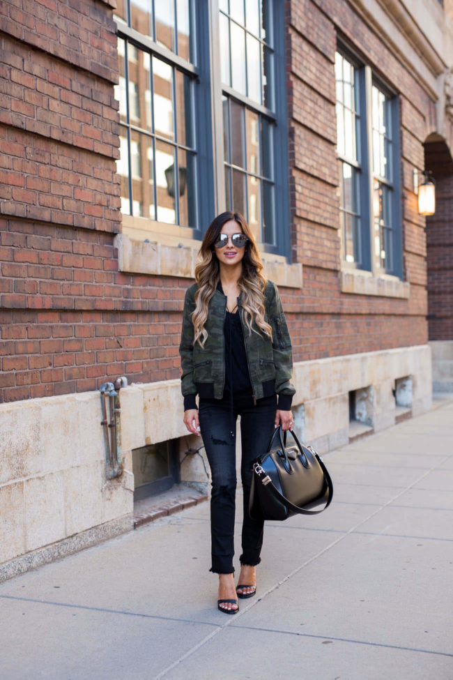 fashion blogger mia mia wearing a sanctuary camouflage jacket from nordstrom and black jeans