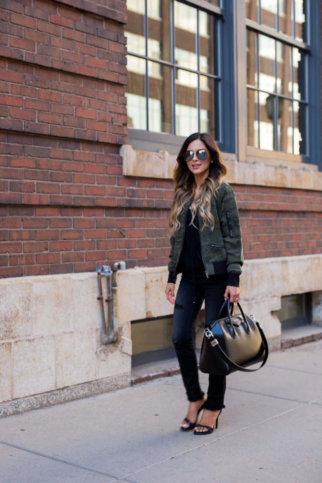 fashion blogger mia mia mine wearing a camouflage jacket and black skinny jeans
