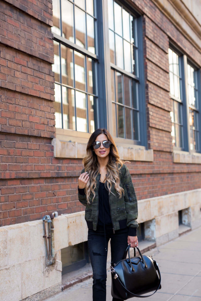 fashion blogger mia mia mine wearing a camouflage jacket and black jeans