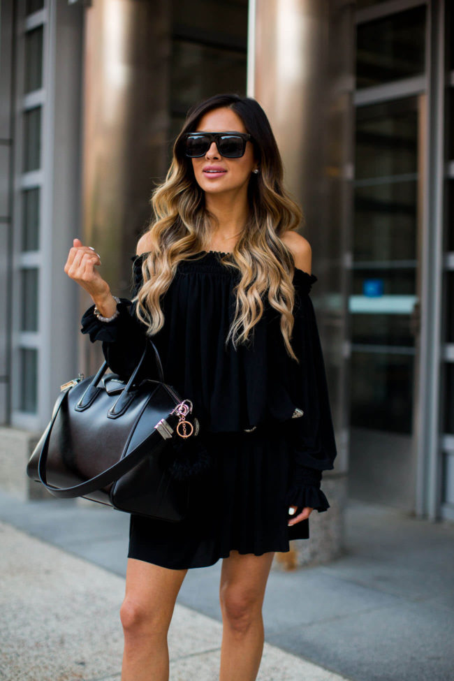 fashion blogger mia mia mine wearing a black peasant dress by norma kamali and black booties by steve madden