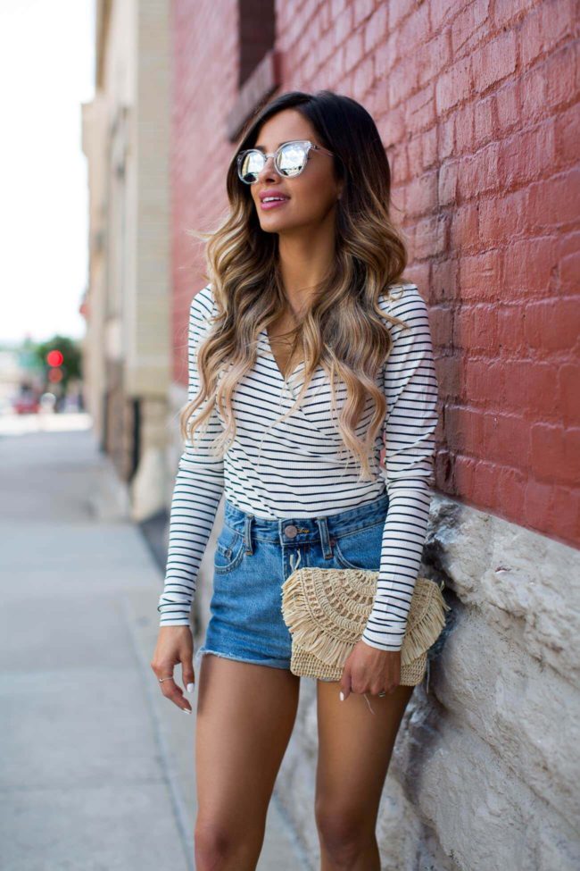 fashion blogger mia mia mine wearing quay mirrored sunglasses and a striped bodysuit from shopbop