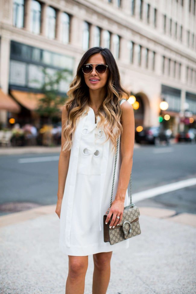 fashion blogger mia mia mine wearing a lace-up dress from shopbop and a gucci bag