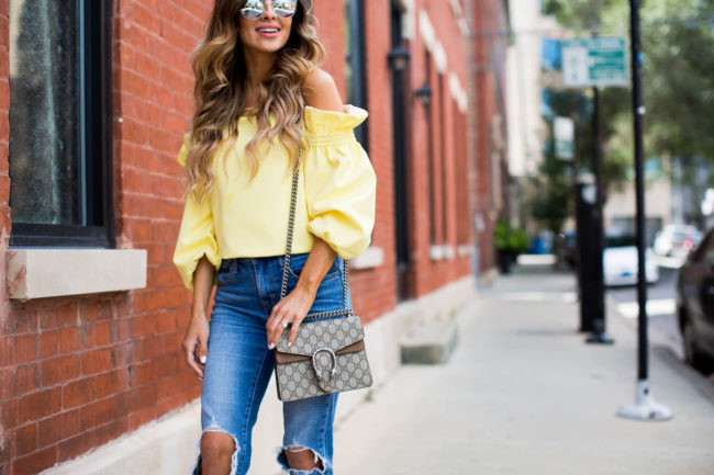 fashion blogger mia mia mine in a yellow off-the-shoulder top from shopbop and levis jeans