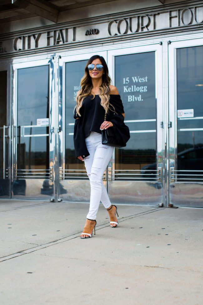 fashion blogger mia mia mine in a black cutout top and white topshop jeans
