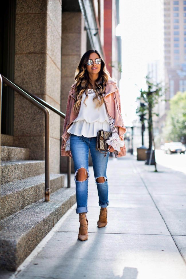 Mia mia mine wearing a white lace top and pink moto jacket by free people