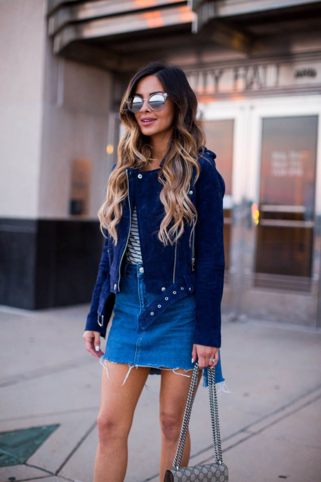 fashion blogger mia mia mine in a blue suede jacket and denim skirt