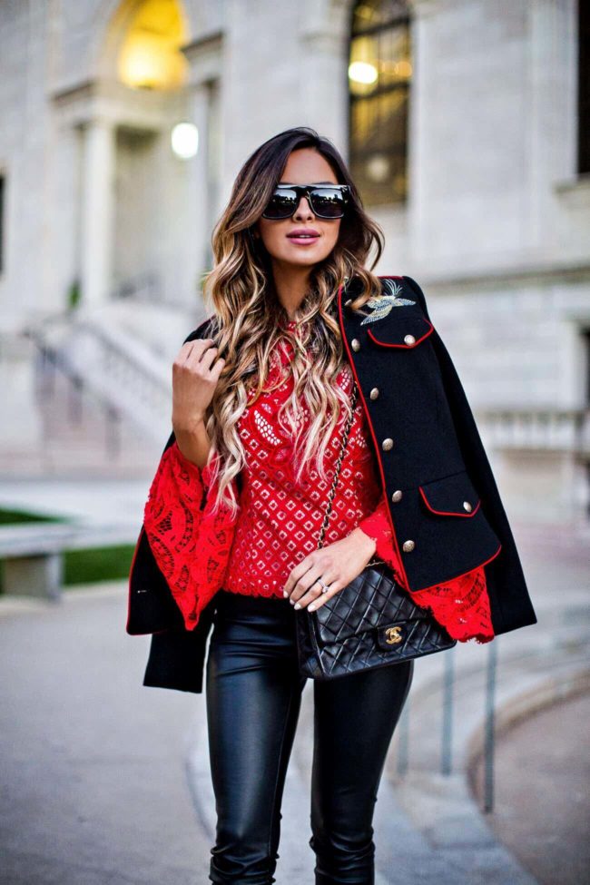 fashion blogger mia mia mine in a red lace bell sleeve top from revolve and leather pants from shopbop
