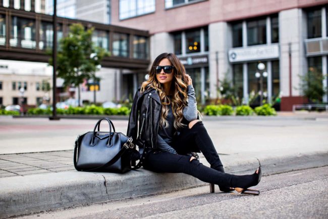 MN blogger mia mia mine carrying a leather jacket and black jeans from nordstrom