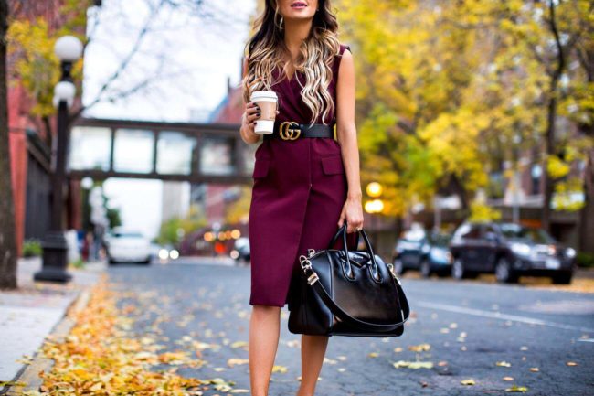 fashion blogger mia mia mine wearing a burgundy sleeveless trench coat from nordstrom