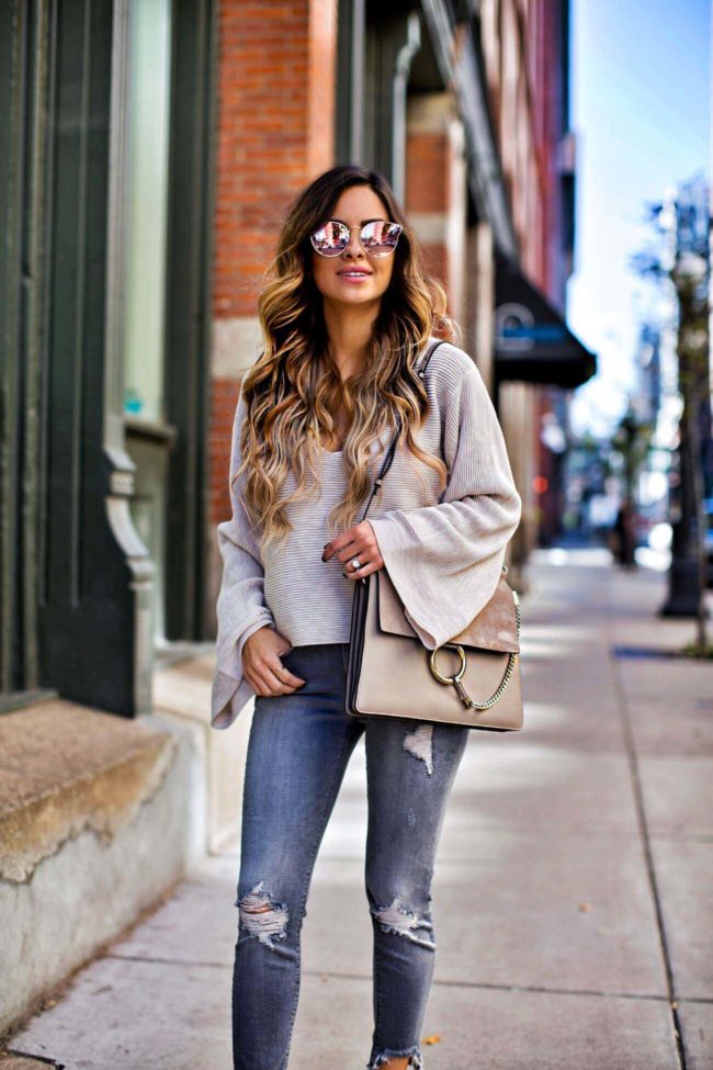 fashion blogger mia mia mine carrying a chloe faye bag in motty grey color