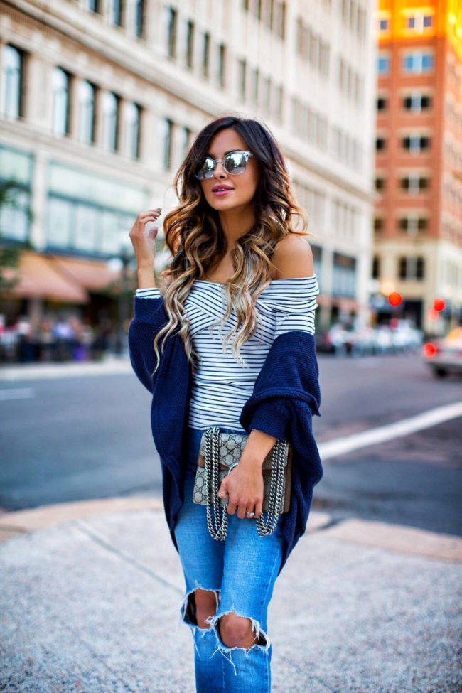 fashion blogger mia mia mine wearing a striped top for fall from macys