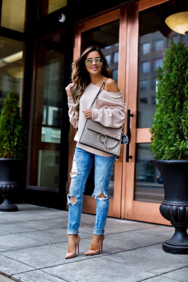 fashion blogger mia mia mine wearing a pink off-the-shoulder sweater by free people