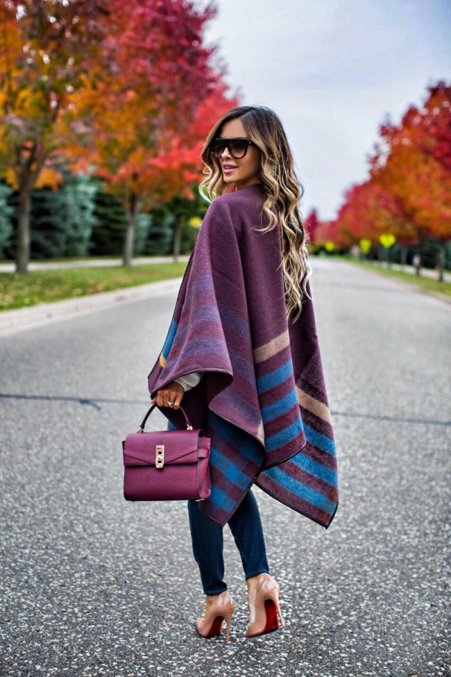 fashion blogger mia mia mine wearing a fall outfit from henri bendel