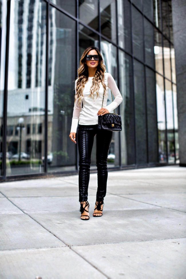 fashion blogger mia mia mine wearing lace-up leather pants and a chanel bag