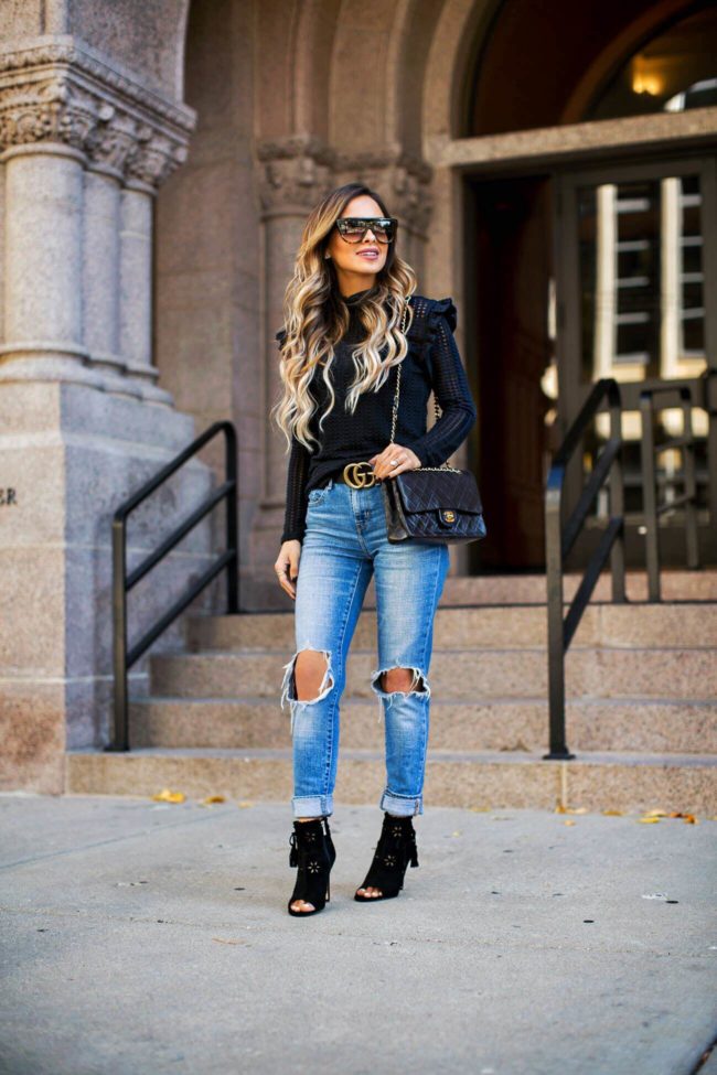 fashion blogger mia mia mine wearing a gucci double g buckle belt and black booties