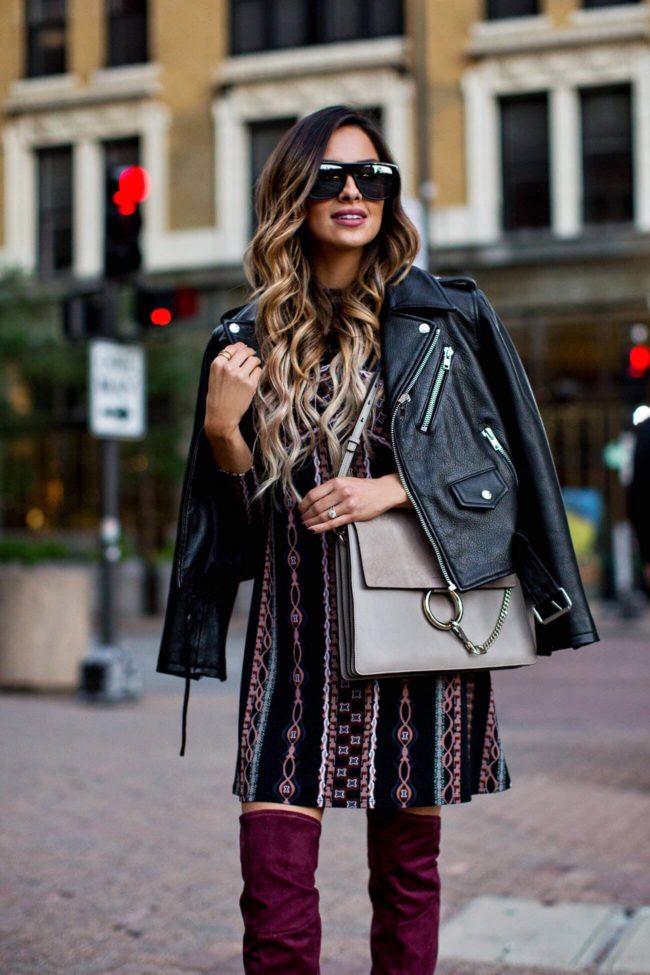 mia mia mine wearing a leather jacket and a fall dress from nordstrom
