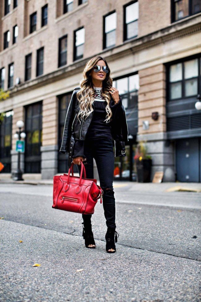 mn fashion blogger mia mia mine wearing a black embroidered top by free people and ivanka trump black booties