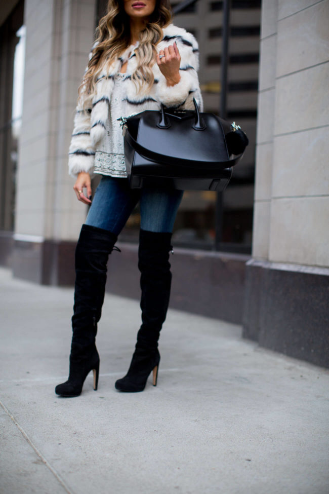 Fashion blogger Mia Mia Mine wearing black over-the-knee boots from Nordstrom and carrying a Givenchy Antigona bag