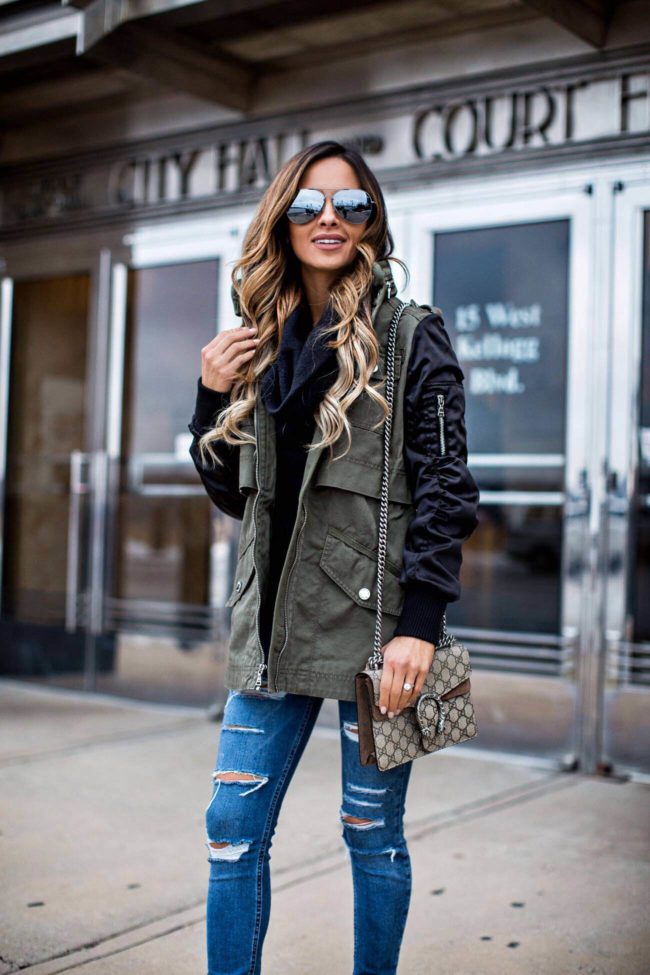 Fashion blogger Mia Mia Mine wearing a mixed media jacket from Express Black Friday sale