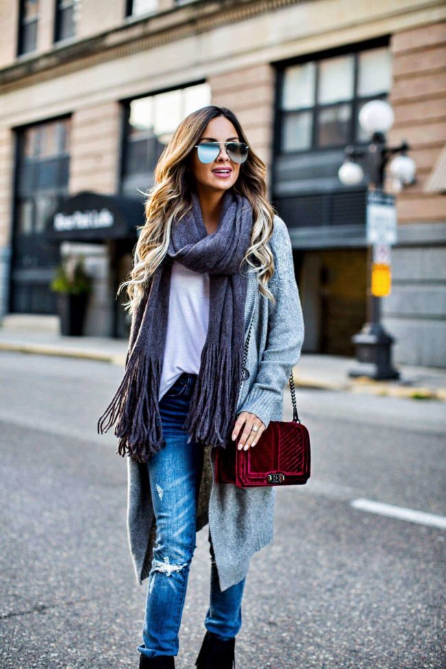 MN fashion blogger mia mia mine wearing a fringe scarf by free people and a gray sweater from nordstrom