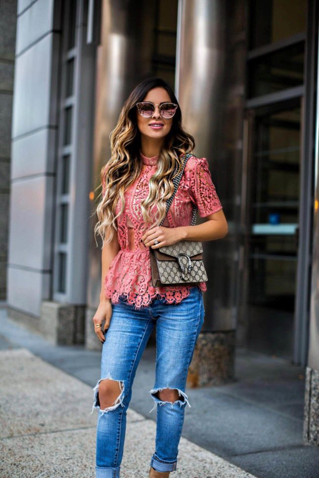 fashion blogger mia mia mine wearing a pink lace top and ripped jeans from shopbop