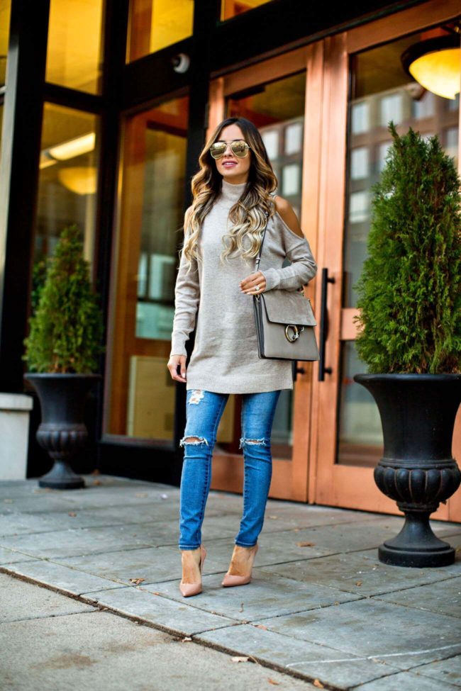 fashion blogger mia mia mine in a cold shoulder sweater from nordstrom and christian louboutin heels