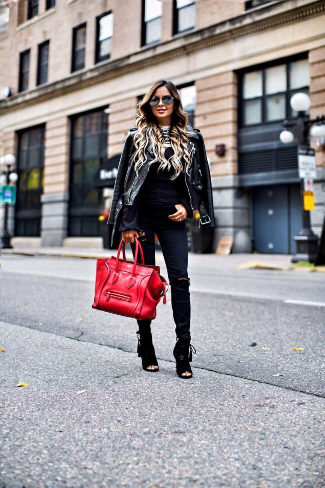 mn fashion blogger mia mia mine wearing a leather jacket and black booties from nordstrom carrying a celine bag