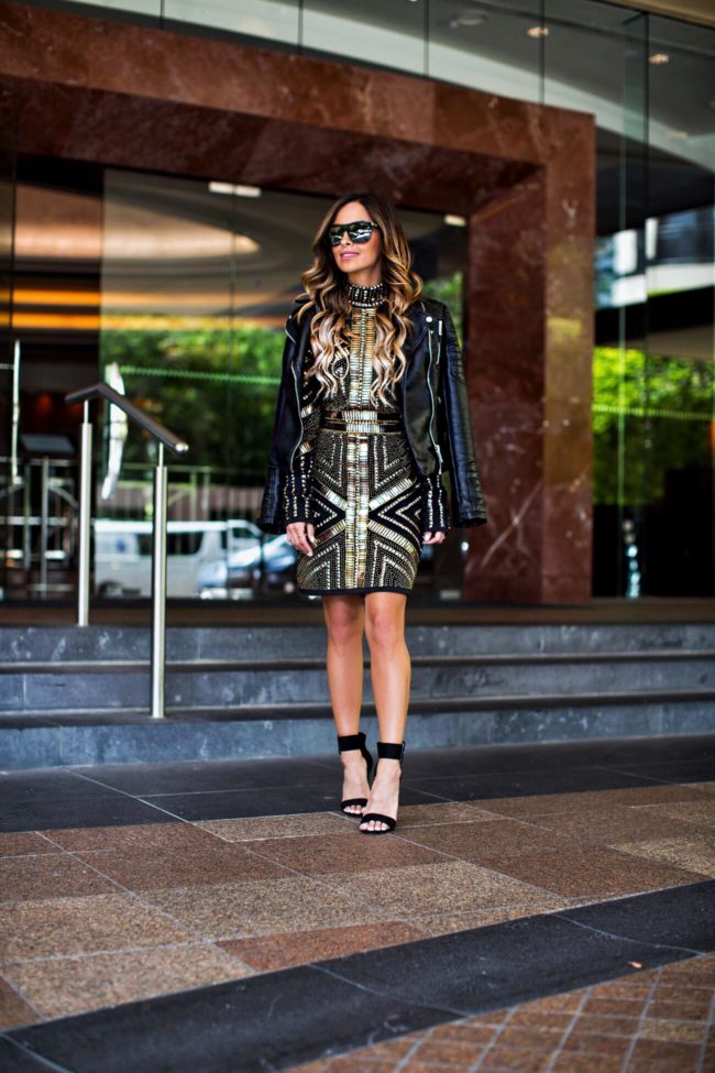 Fashion blogger Mia Mia Mine wearing a gold sequin holiday party dress from missguided