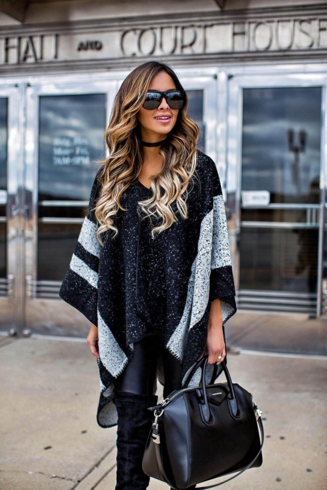 fashion blogger Maria Vizuete wearing a black and gray cape from sole society and black over-the-knee boots