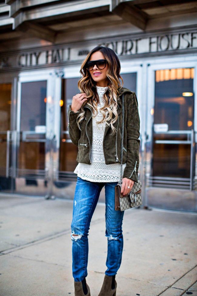 fashion blogger mia mia mine wearing a green suede moto jacket and a lace top from nordstrom