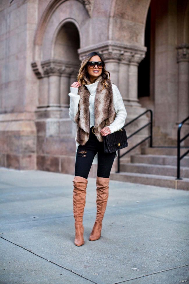 fashion blogger mia mia mine wearing a faux fur vest and over-the-knee boots and a faux fur vest from nordstrom