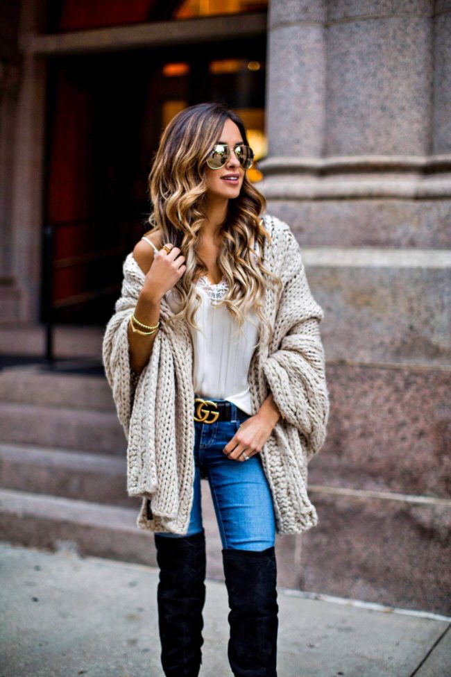 fashion blogger mia mia mine wearing a cable knit wrap and a gucci double g buckle belt
