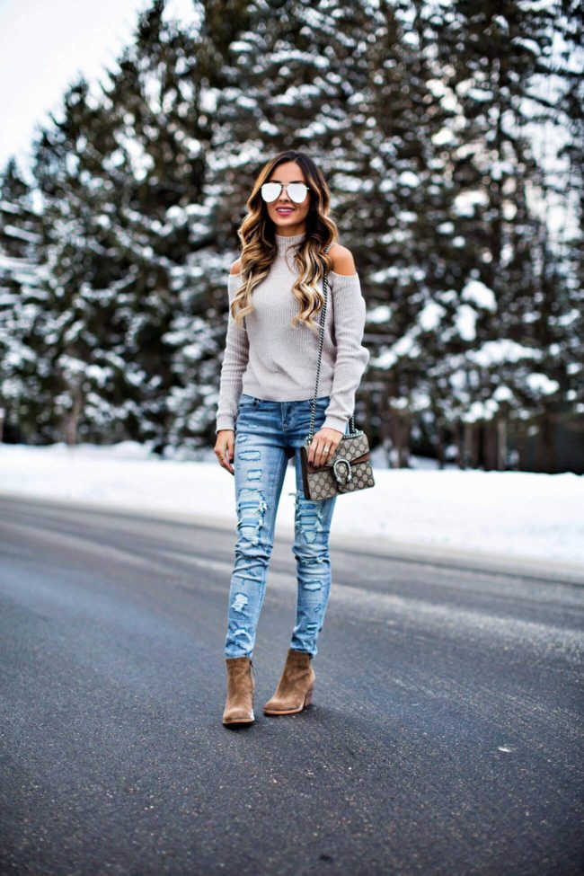 mn fashion blogger mia mia mine wearing a cold-shoulder sweater and ripped jeans from express